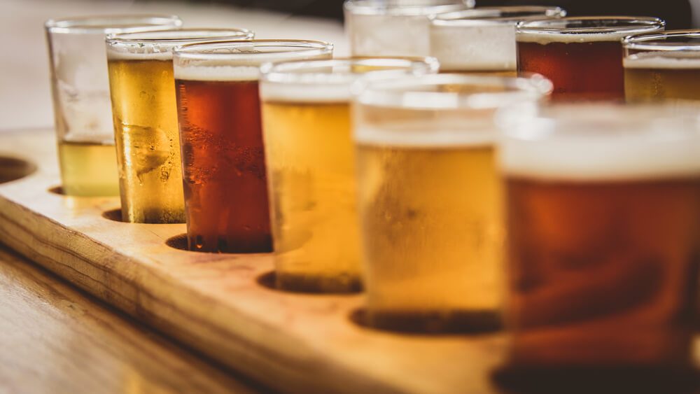 glasses full of beer in a line